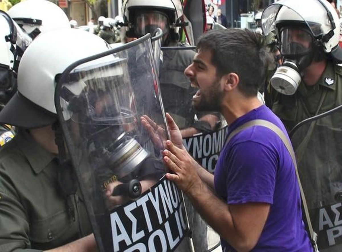 REPEATING, CORRECTING BYLINE - A demonstrator yells at group of riot police during violent demonstrations over austerity measures in Thessaloniki