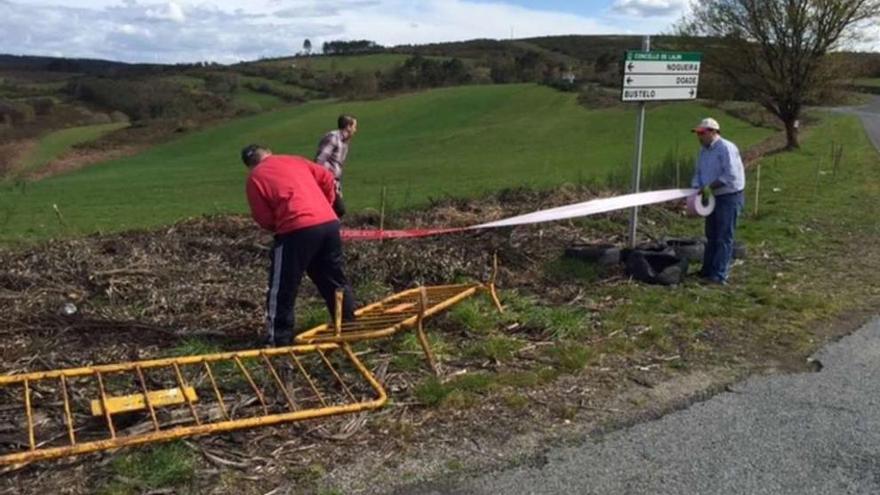 Miembros de la escudería Lalín-Deza encintan, ayer, uno de los tramos del Rali do Cocido.