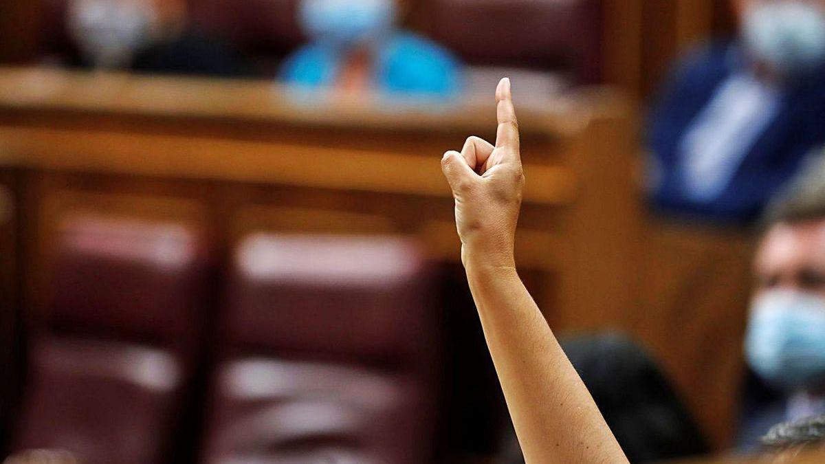 Una diputada marca el sentido del voto a sus compañeros, durante el debate en el Congreso.