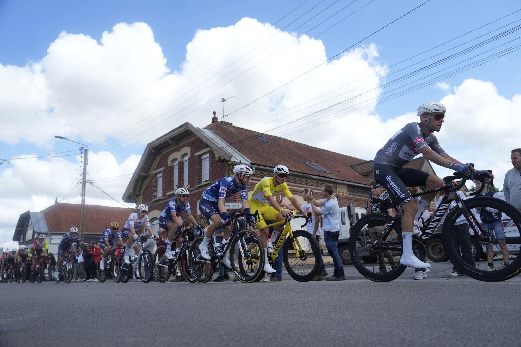 The pack with Netherlands' Mathieu van der Poel wearing the overall leader's yellow jersey rides during the third stage of the Tour de France cycling race over 178.3 kilometers (110.8 miles) with start in Valenciennes and finish in Dunkerque, France, Monday, July 7, 2025. (AP Photo/Mosa'ab Elshamy)