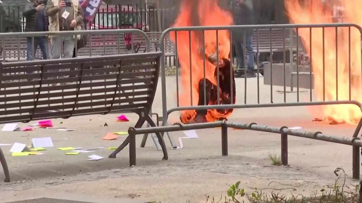 SENSITIVE MATERIAL. THIS IMAGE MAY OFFEND OR DISTURB    A person is covered in flames outside the courthouse where former U.S. President Donald Trump's criminal hush money trial is underway, in New York, U.S., April 19, 2024 in this screen grab taken from a pool video. Reuters TV via REUTERS / SMOUT