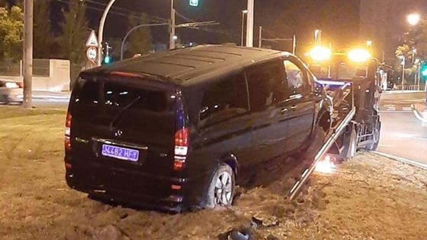 Arriba, una grúa retira el vehículo tras el impacto en una rotonda de San Juan. A la izquierda, detalle del coche.