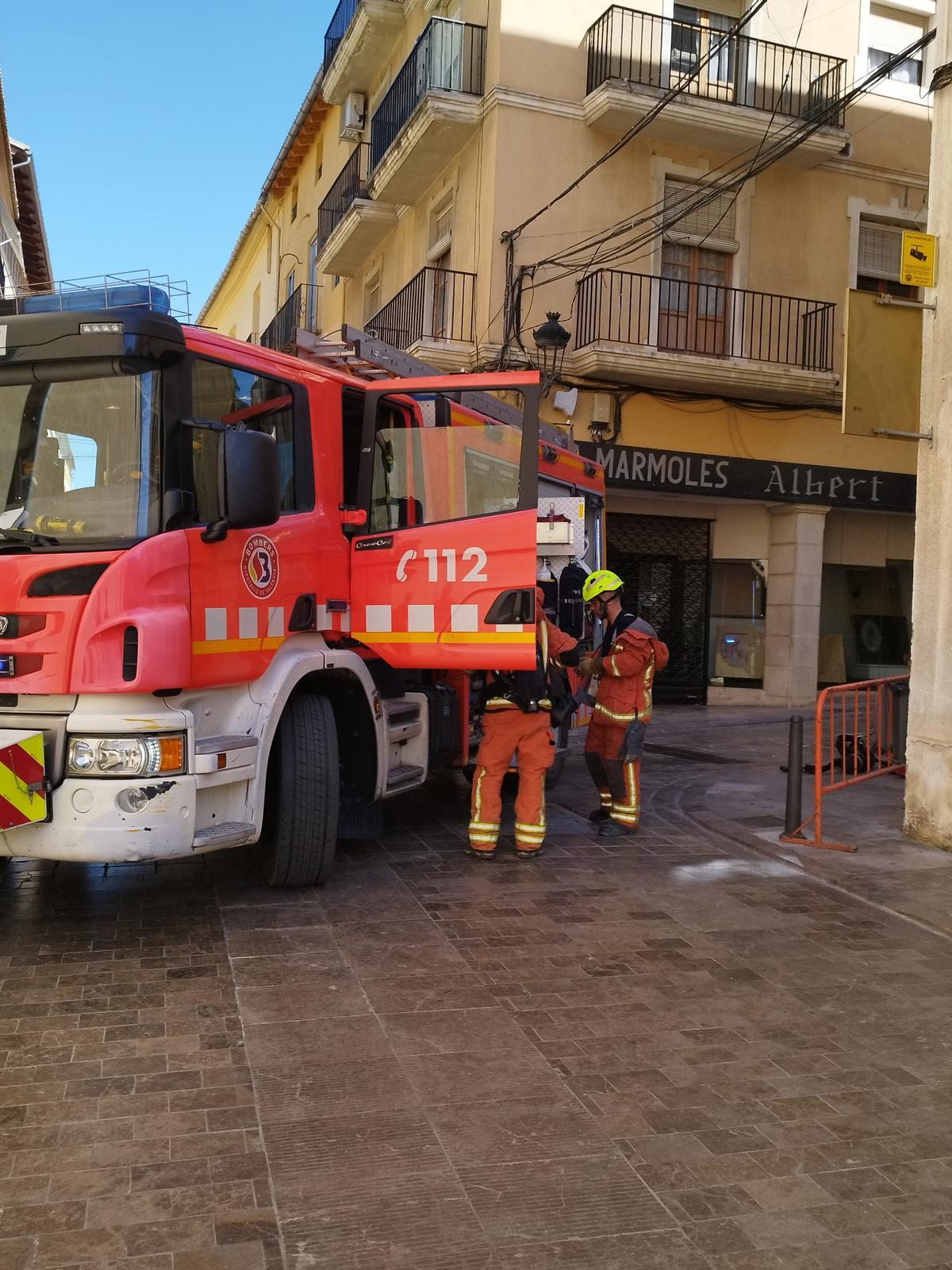 Dotación de bomberos en la calle Pi de Xàtiva.