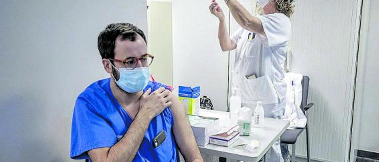 Un sanitario recibiendo la vacuna contra el covid en el hospital de Son Espases. | B. RAMON