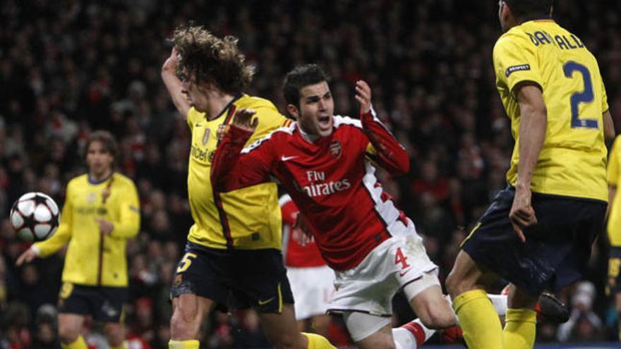 Carles Puyol y Cesc Fabregas disputan un balón en un encuentro de Champions entre el Barcelona y el Arsenal en 2010.