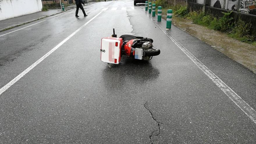 La moto tumbada en la PO-551, en la bajada a Portal do Almacén.//G.N.