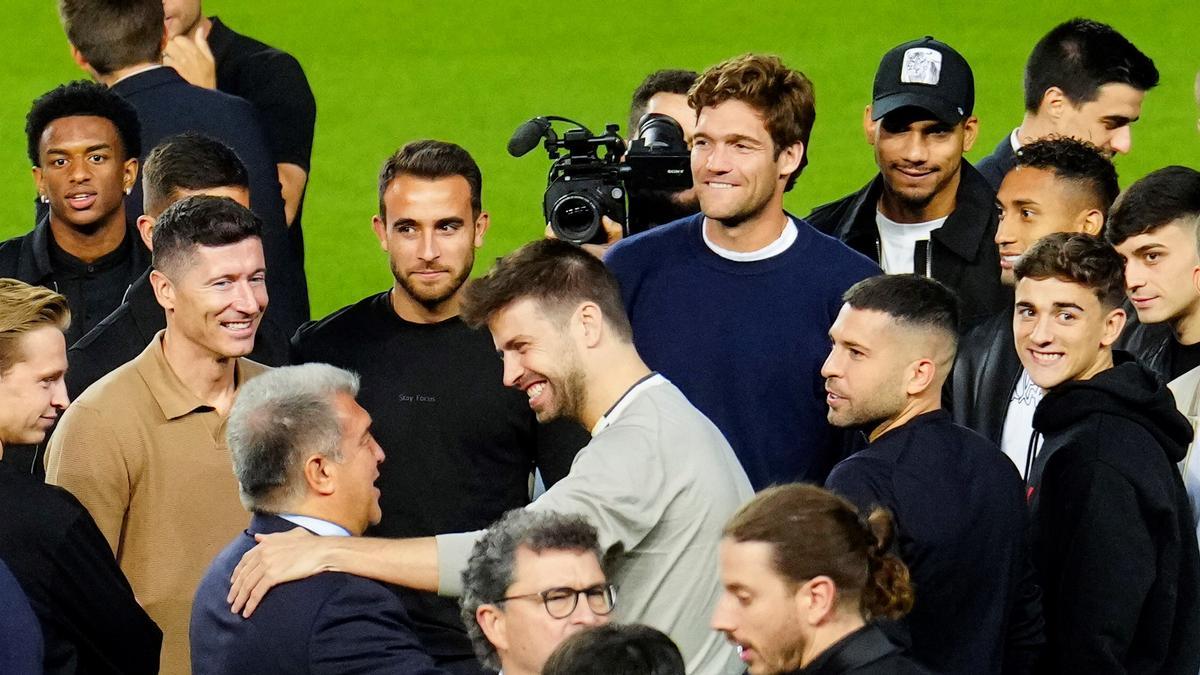 Piqué saluda a Laporta durante el acto de despedida a Busquets en el Camp Nou.