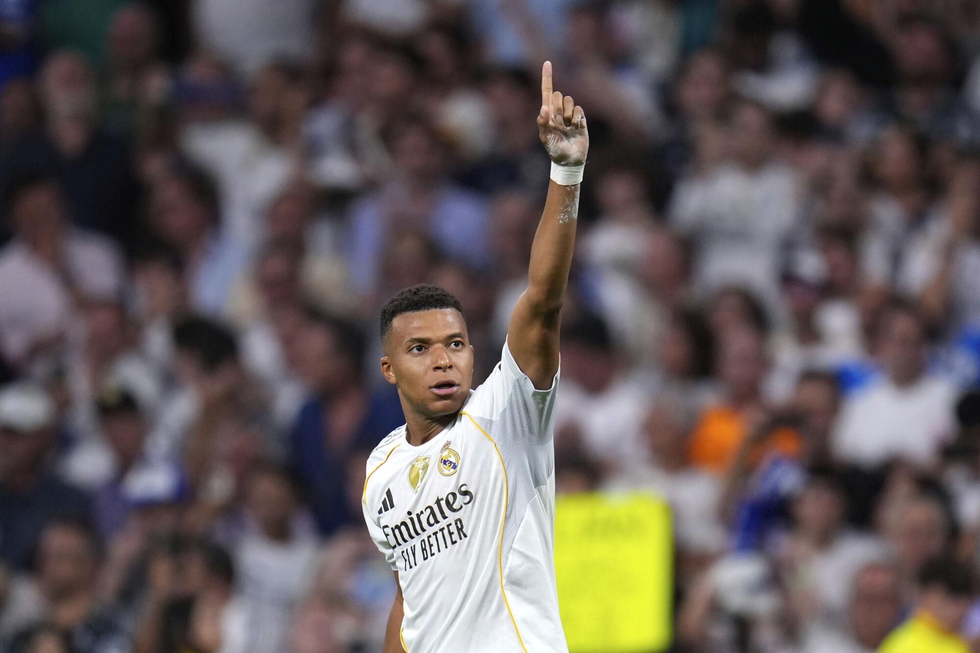 Real Madrid's Kylian Mbappe celebrates after scoring his side's second goal during a Champions League opening phase soccer match between Real Madrid and Marseille at Santiago Bernabeu stadium, in Madrid, Tuesday, Sept. 16, 2025. (AP Photo/Manu Fernandez)