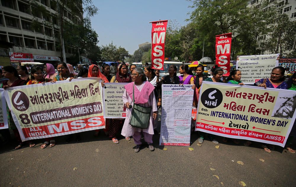 Demonstrators hold banners during a protest ...