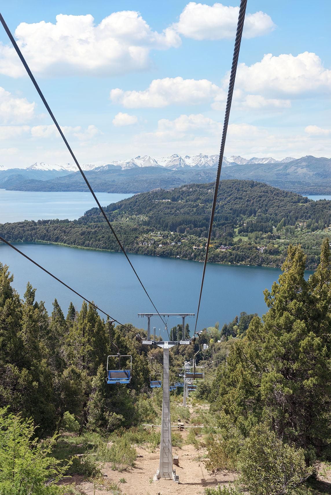 Ascenso en telesilla a cerro Campanario con vistas al lago.