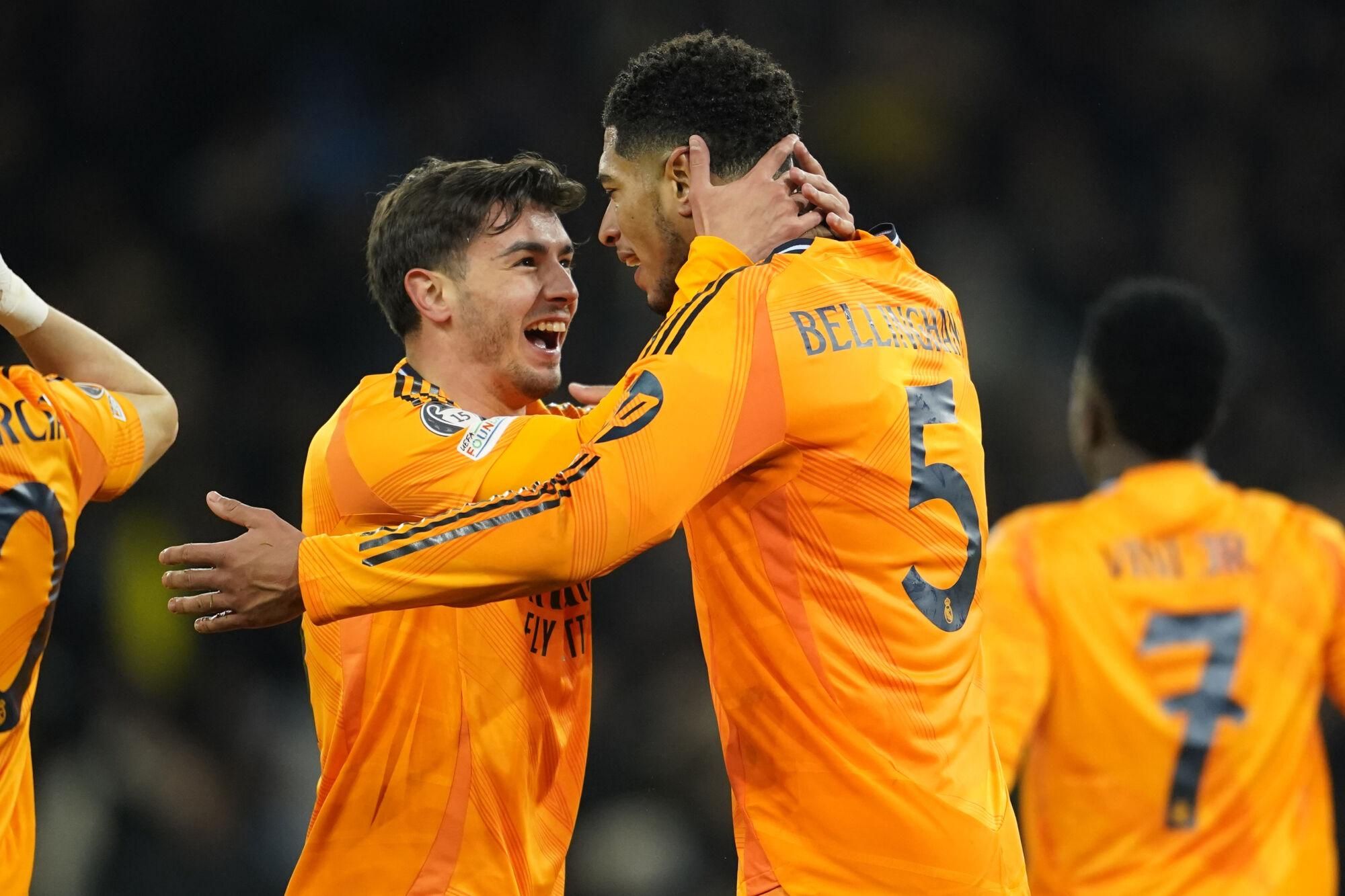 Real Madrid's Jude Bellingham, right, celebrates with Real Madrid's Brahim Diaz after scoring his sides third goal during the Champions League playoff first leg soccer match between Manchester City and Real Madrid at the Etihad Stadium in Manchester, England, Tuesday, Feb. 11, 2025. (AP Photo/Dave Thompson)