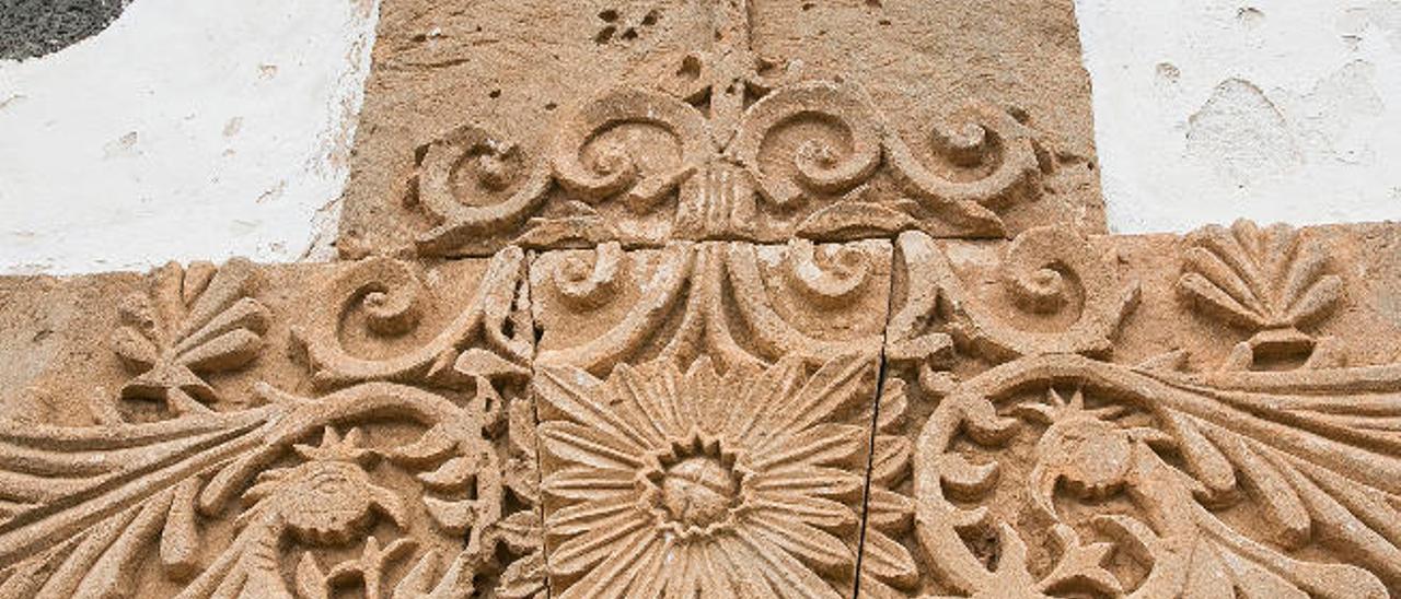Sobre el dintel de la puerta, rematado por una cruz, se labraron motivos vegetales que recuerdan a la cultura azteca.