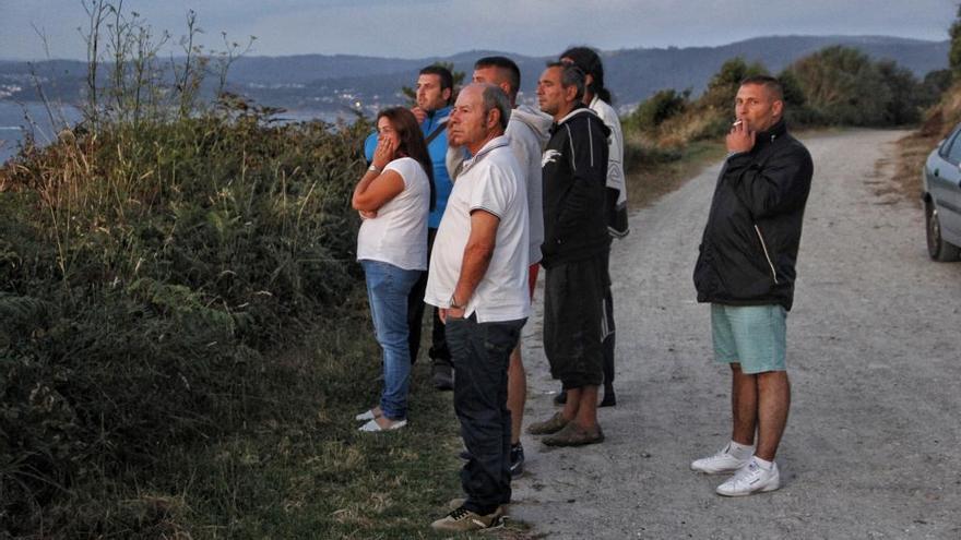 Varias personas siguen el rescate, a última hora de esta tarde. // Santos Álvarez