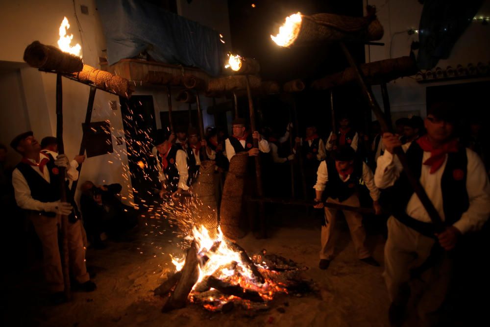 Villagers hold torches during the Divina Pastora ...