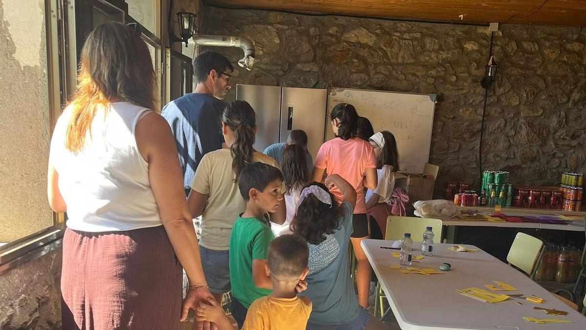 Algunos de los asistentes al taller en la cola para pegar
