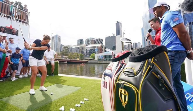 La tenista australiana Ashleigh Barty (L) se prepara para jugar un tiro de golf durante la inauguración oficial de la competencia de golf de la Copa Presidentes 2019 en Crown Riverwalk en Melbourne, Australia.