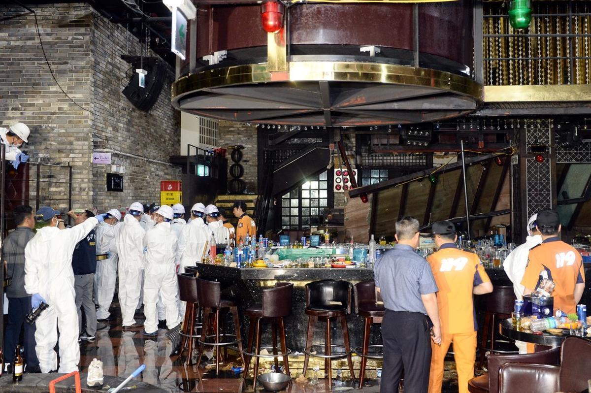 South Korean firefighters and officials examine the collapsed structure of a nightclub where several athletes competing at the World Aquatics Championships were dancing, in Gwangju, South Korea, July 27, 2019.  Yonhap via REUTERS   ATTENTION EDITORS - THIS IMAGE HAS BEEN SUPPLIED BY A THIRD PARTY. SOUTH KOREA OUT. NO COMMERCIAL OR EDITORIAL SALES IN SOUTH KOREA. NO RESALES. NO ARCHIVE.
