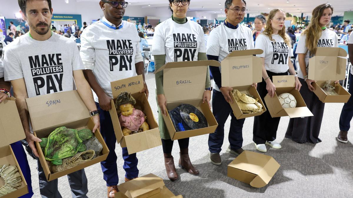 Members of Greenpeace International display personal items and symbolic objects impacted by extreme weather and the climate crisis, during the United Nations Climate Change Conference (COP29), in Baku, Azerbaijan November 18, 2024. REUTERS/Murad Sezer
