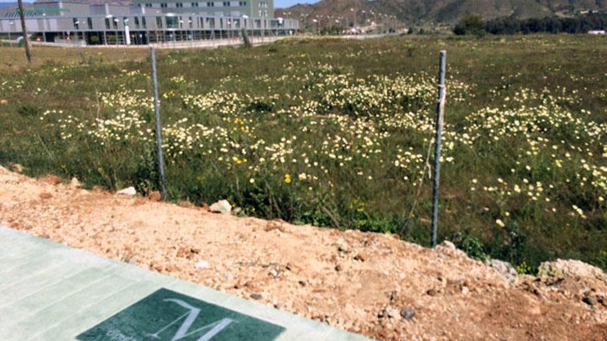 Una placa de la Diputación de Málaga, en la acera de la vía que da acceso al hospital.