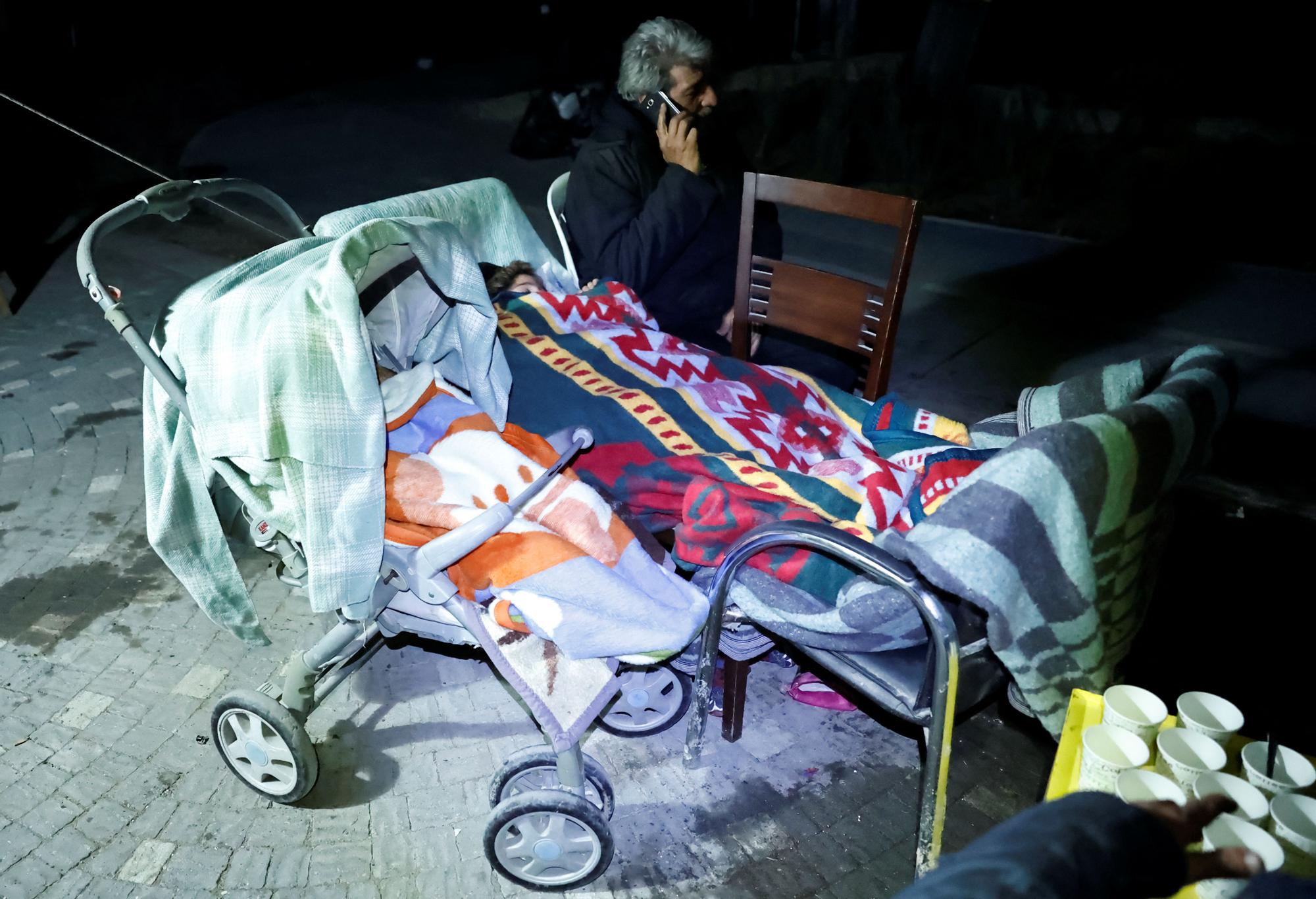 People react after a quake in Antakya in Hatay province, Turkey