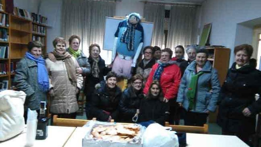 Foto de grupo con el muñeco. En primer plano orejas y licor para celebrarlo.