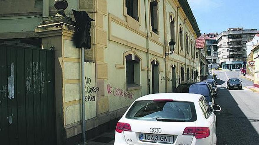 Coches estacionados, ayer, junto a la fábrica de conservas, con la señal de prohibición tapada, en Candás.