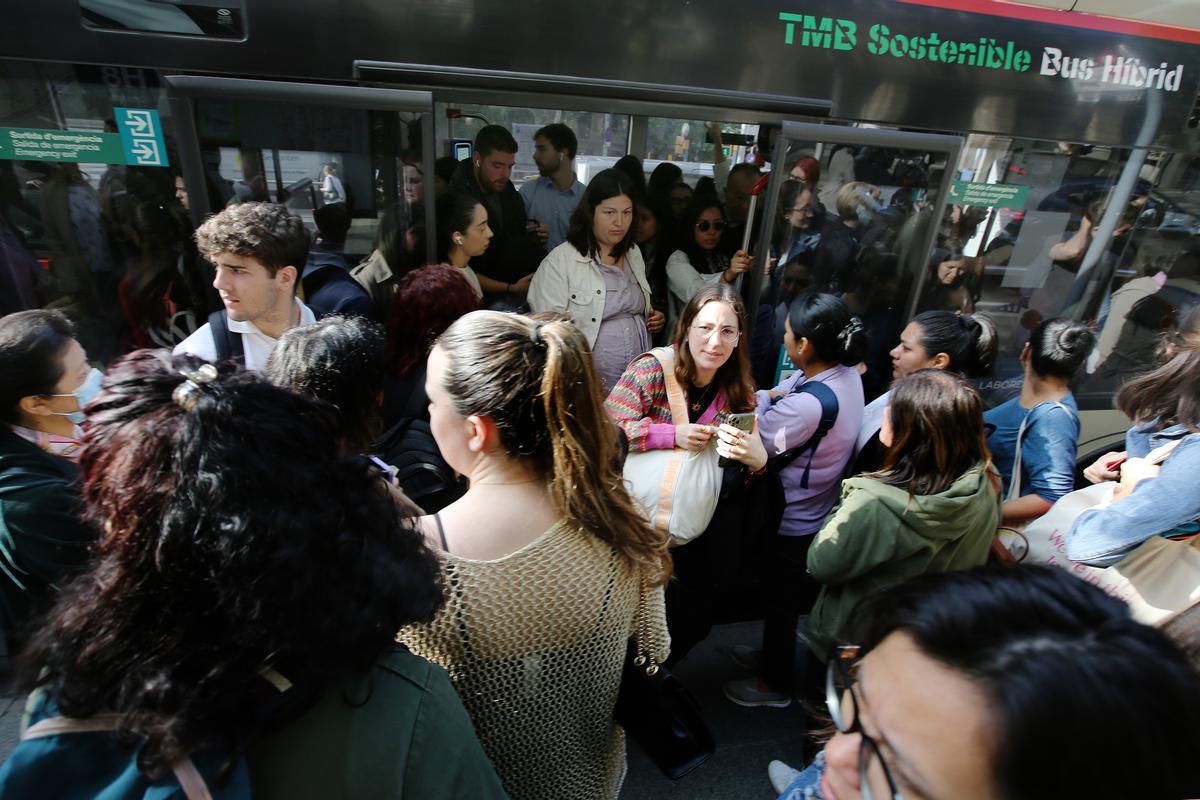 Subidas y bajadas de un bus, durante la huelga de este jueves en Barcelona