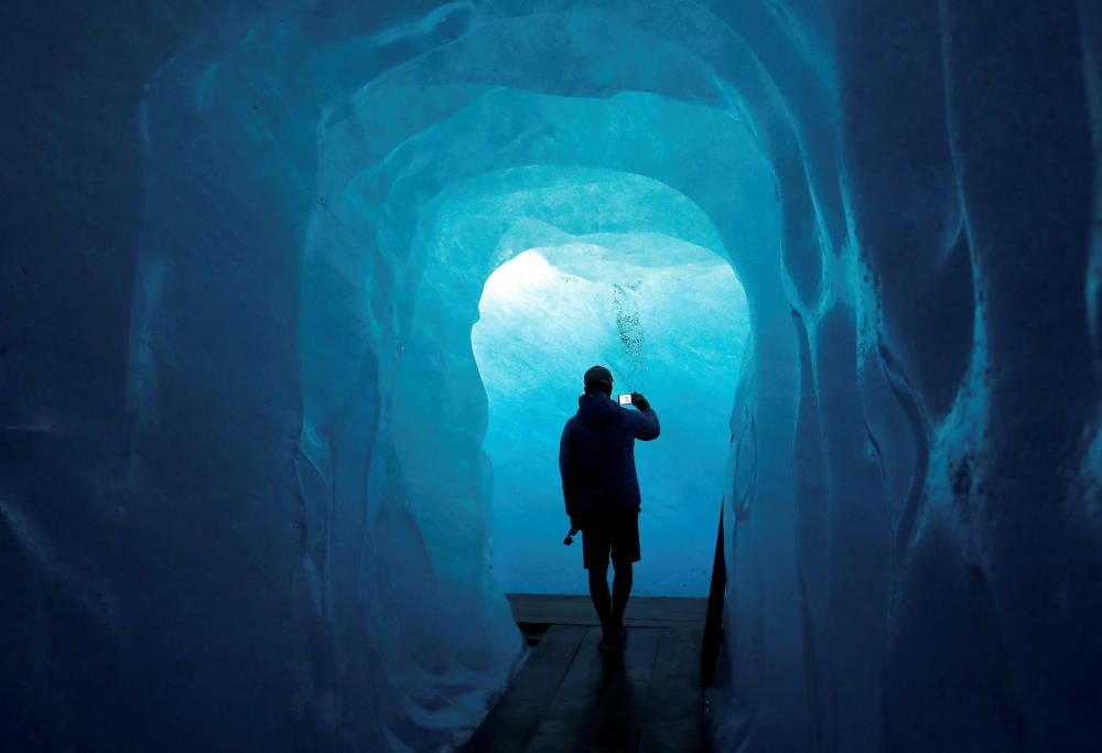 A tourist takes a picture in the Ice Cave at the ...