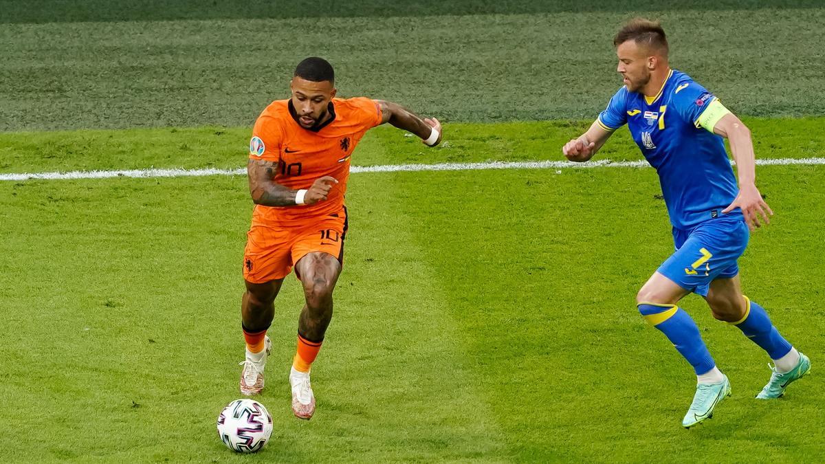 Depay intenta escaparse del ucraniano Yarmolenko en el primer partido del grupo.