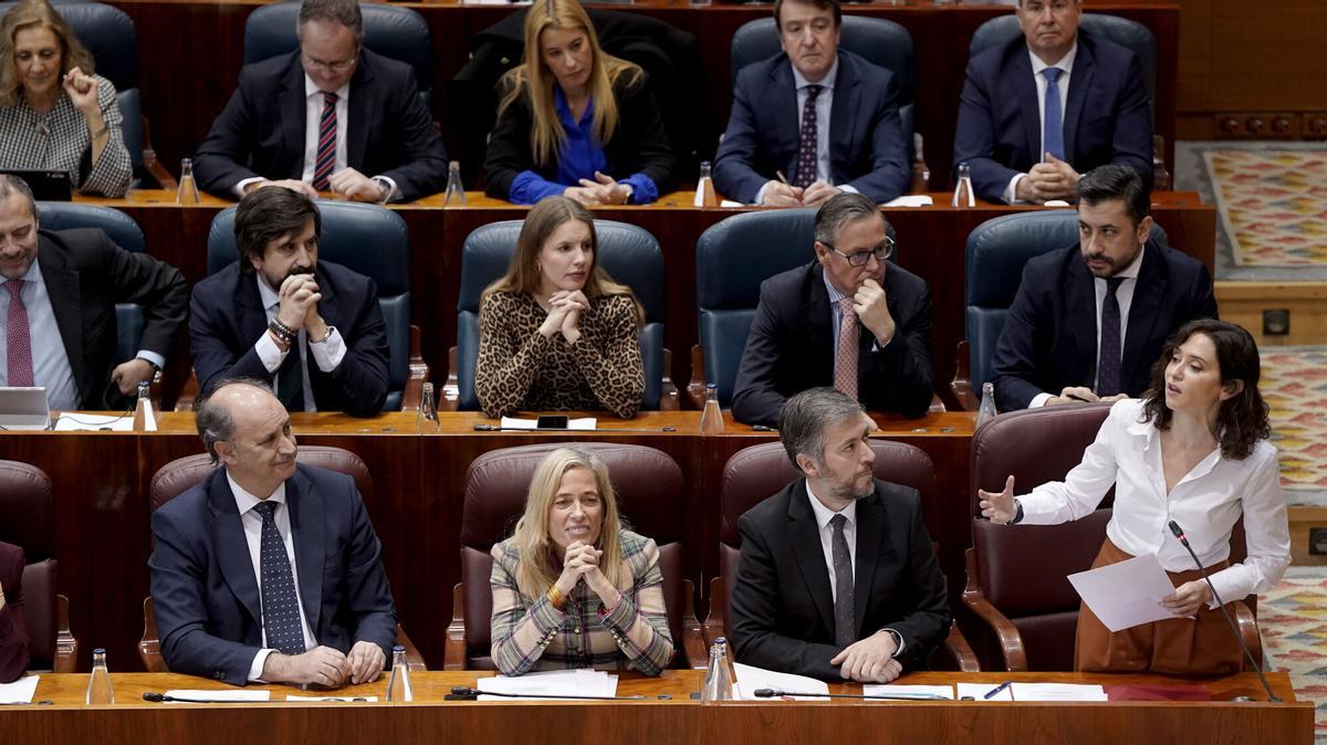 La presidenta de la Comunidad de Madrid, Isabel Díaz Ayuso, en le último Pleno de la ASsamblea. Tras ella, el portavoz del Grupo Popular, Carlos Díaz-Pache.l de la Asamblea de Madrid
