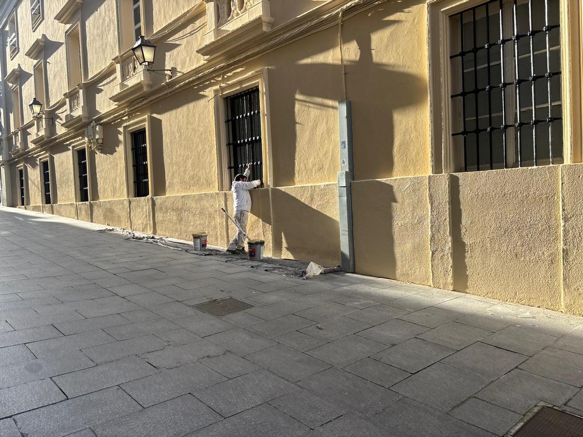 Uno de los pintores da los últimos remates en el edificio de Capitanía de Badajoz.