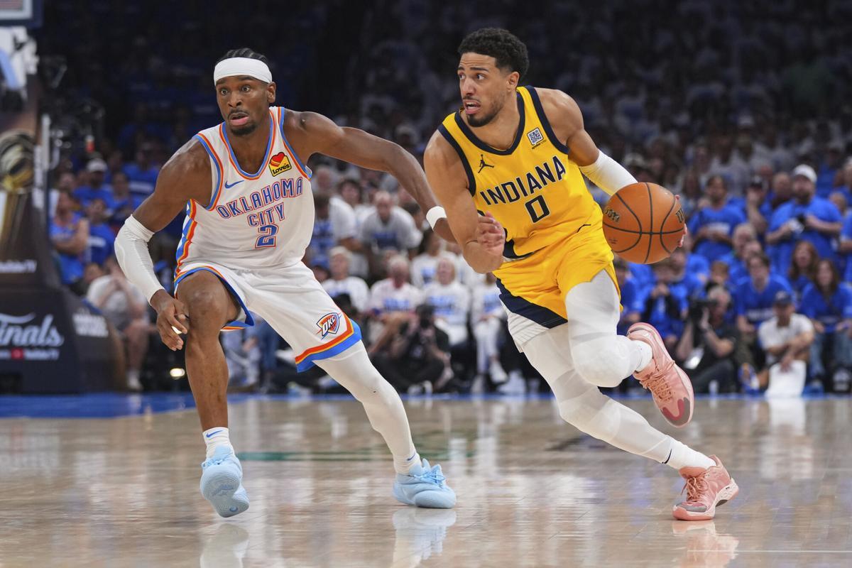 Indiana Pacers guard Tyrese Haliburton (0) drives past Oklahoma City Thunder guard Shai Gilgeous-Alexander (2) during the second half of Game 5 of the NBA Finals basketball series, Monday, June 16, 2025, in Oklahoma City. (AP Photo/Kyle Phillips)