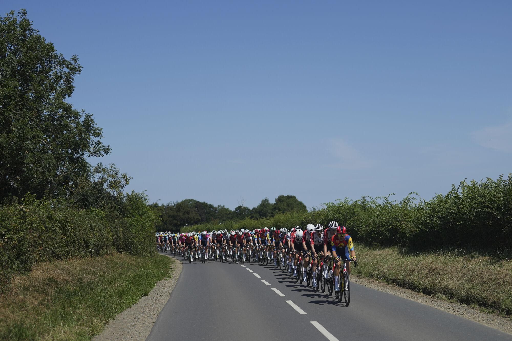 The pack rides during the sixth stage of the Tour de France cycling race over 201.5 kilometers (125.2 miles) with start in Bayeux and finish in Vire Normandy, France, Thursday, July 10, 2025. (AP Photo/Thibault Camus)