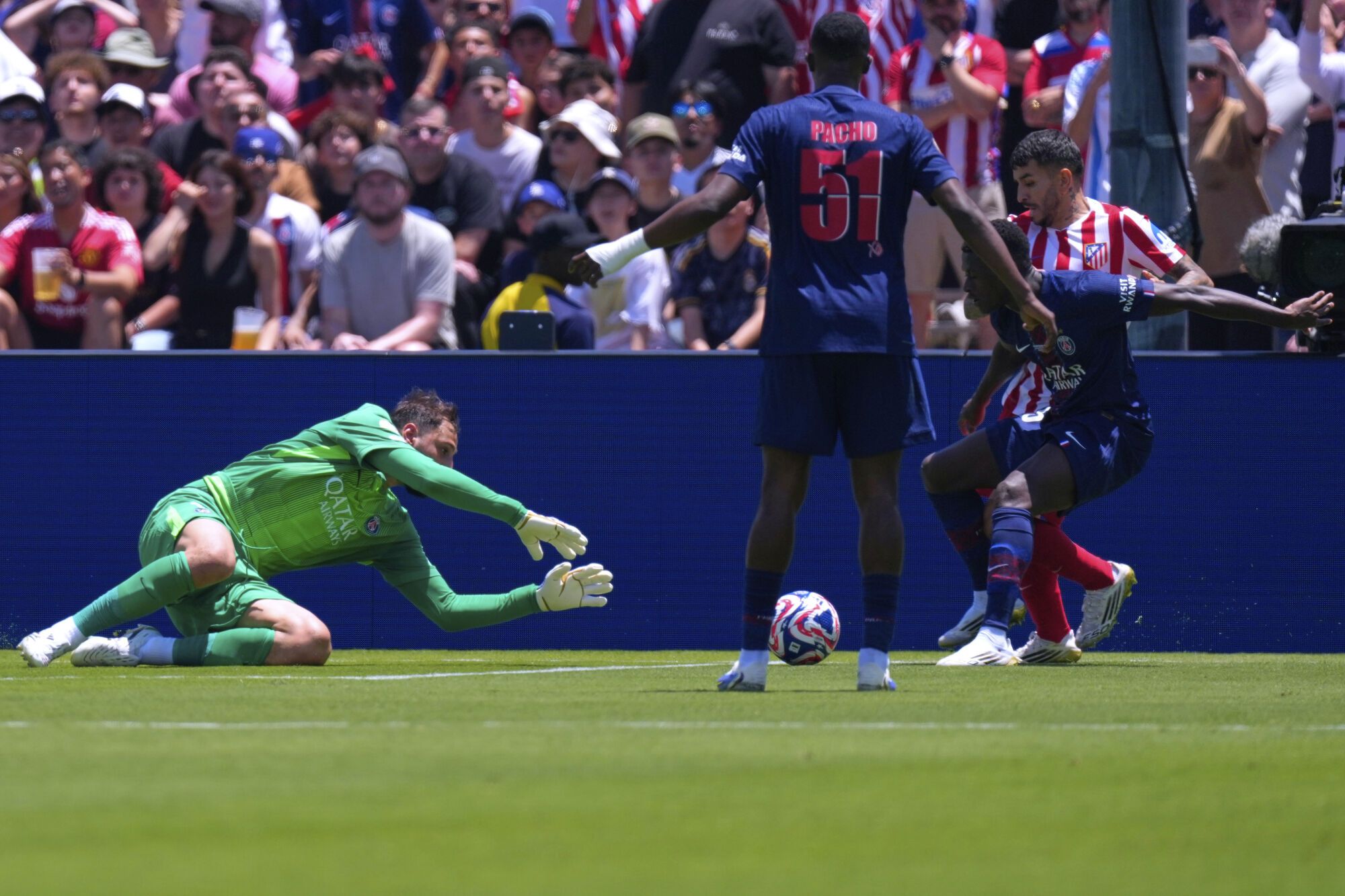 Paris Saint-Germain's goalkeeper Gianluigi Donnarumma, left, dives for the ball against Atletico Madrid's Angel Correa, right, during the Club World Cup group B soccer match between PSG and Atletico Madrid, in Pasadena, Calif., Sunday, June 15, 2025. (AP Photo/Mark J. Terrill)