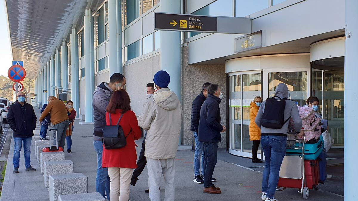 Pasajeros ante la terminal de salidas de Peinador.