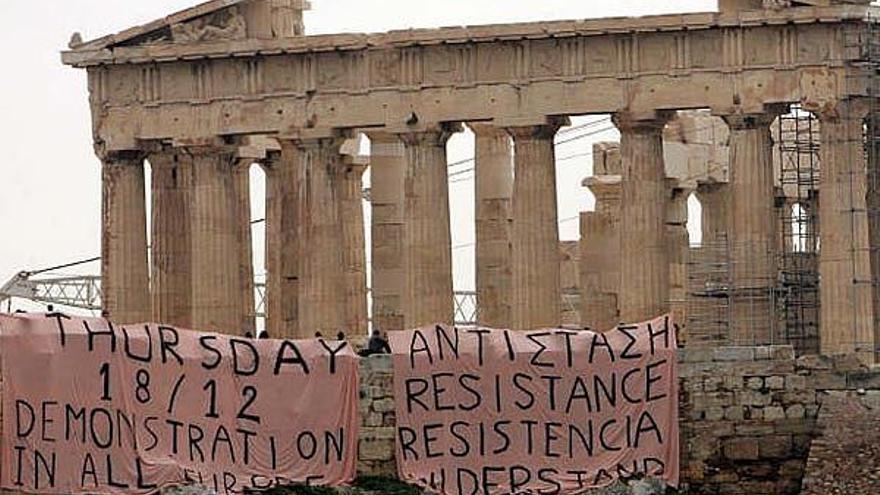 Dos pancartas en las que se puede leer &quot;Resistencia&quot; en cuatro idiomas y una convocatoria para una manifestación mañana en toda Europa, colgadas junto al Partenón, en la Acrópolis de Atenas, Grecia, hoy miércoles 17 de diciembre. Estudiantes y escolares tienen previsto concentrarse hoy frente a los tribunales de Atenas en apoyo de los detenidos durante los diez días de disturbios por la muerte del joven Alexis Grigorópulos por un disparó de un policía el 6 de diciembre en un barrio de la capital.