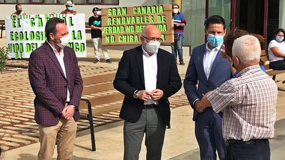 Antonio Morales y Héctor Suárez, frente de las instalaciones del Cubillo con manifestantes al fondo de Salvar Chira-Soria.