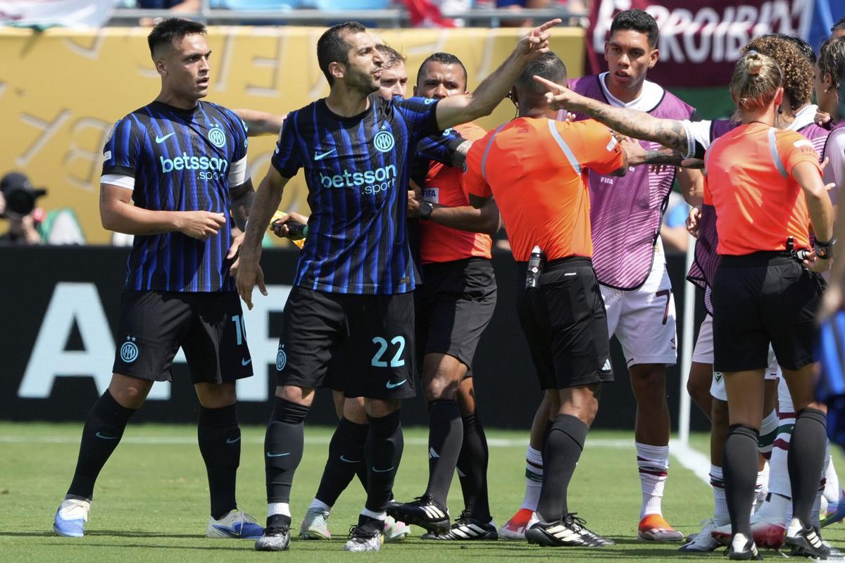 Inter Milan's Henrikh Mkhitaryan, left, argues to Fluminense players during the Club World Cup round of 16 soccer match between Inter Milan and Fluminense in Charlotte, N.C., Monday, June 30, 2025. (AP Photo/Chris Carlson)
