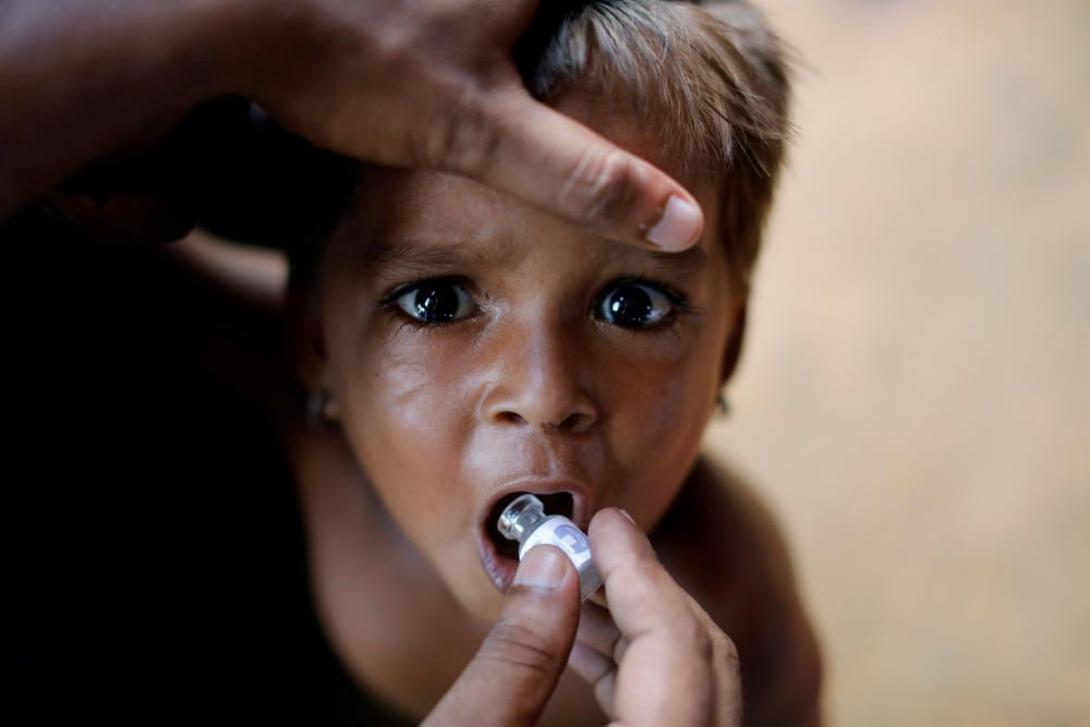 A Rohingya refugee child gets an oral cholera ...