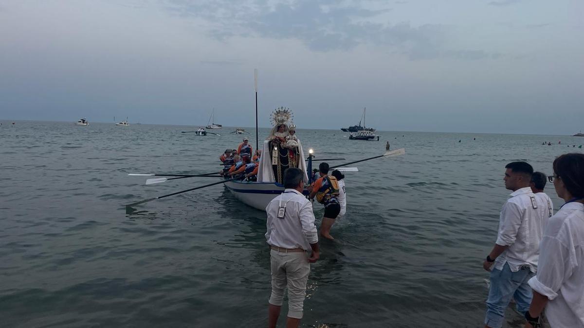 La Virgen del Carmen desembarca en el Postiguet entre antorchas, fuego y fervor marinero