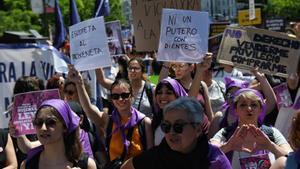 Archivo - Varias personas sujetan pancartas en una manifestación para reclamar la abolición de la prostitución, a 28 de mayo de 2022, en Madrid (España).