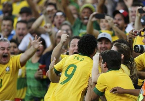 Brazil's Fred celebrates with fans after scoring a goal during their Confederations Cup final soccer match against Spain at the Estadio Maracana in Rio de Janeiro