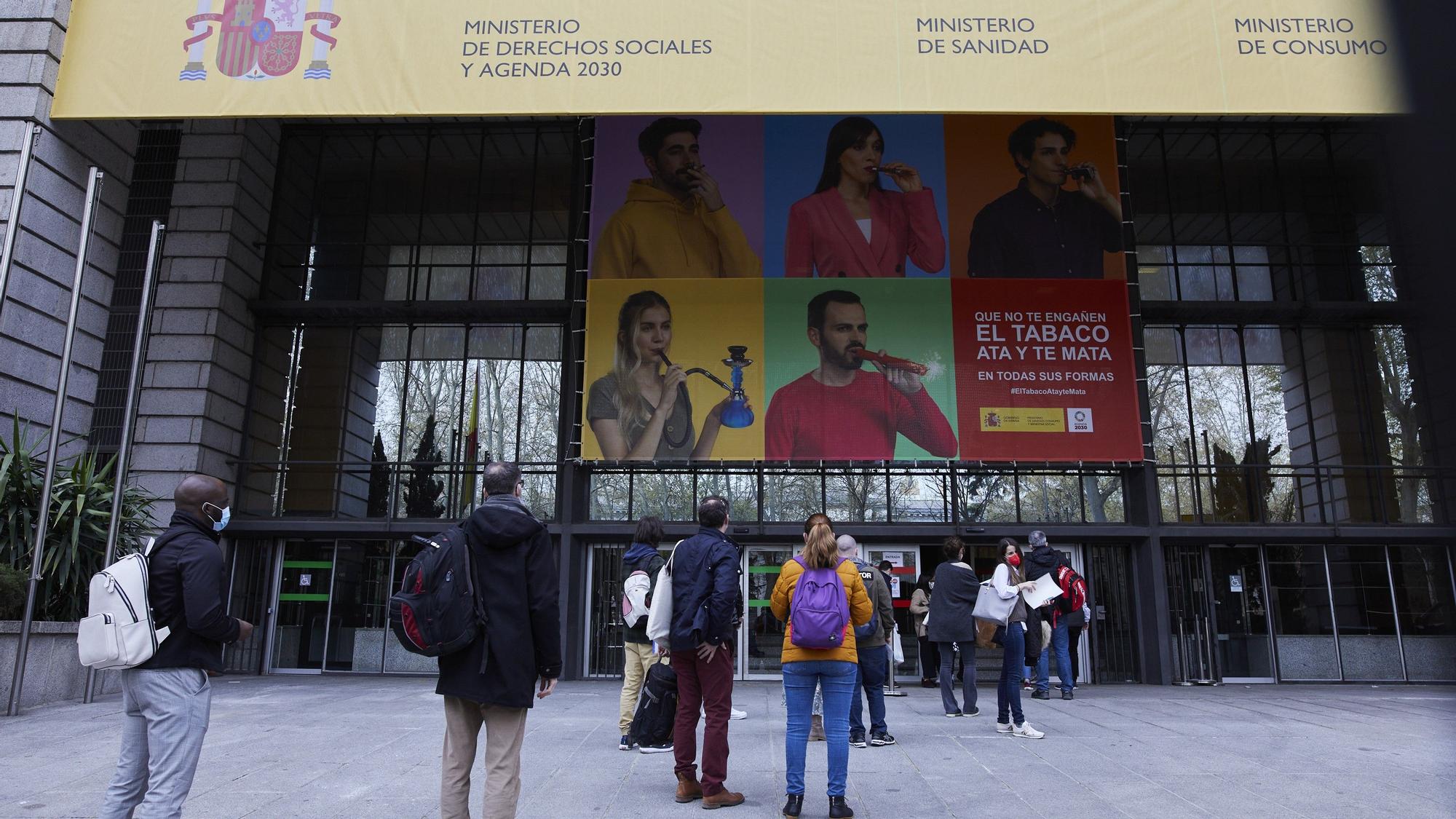 Varias personas hacen cola en el exterior del Ministerio de Sanidad para acceder al centro de examen de las pruebas de Formación Sanitaria Especializada, el año pasado en Madrid.