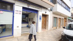 Una mujer, frente a la administración de Guadassuar.
