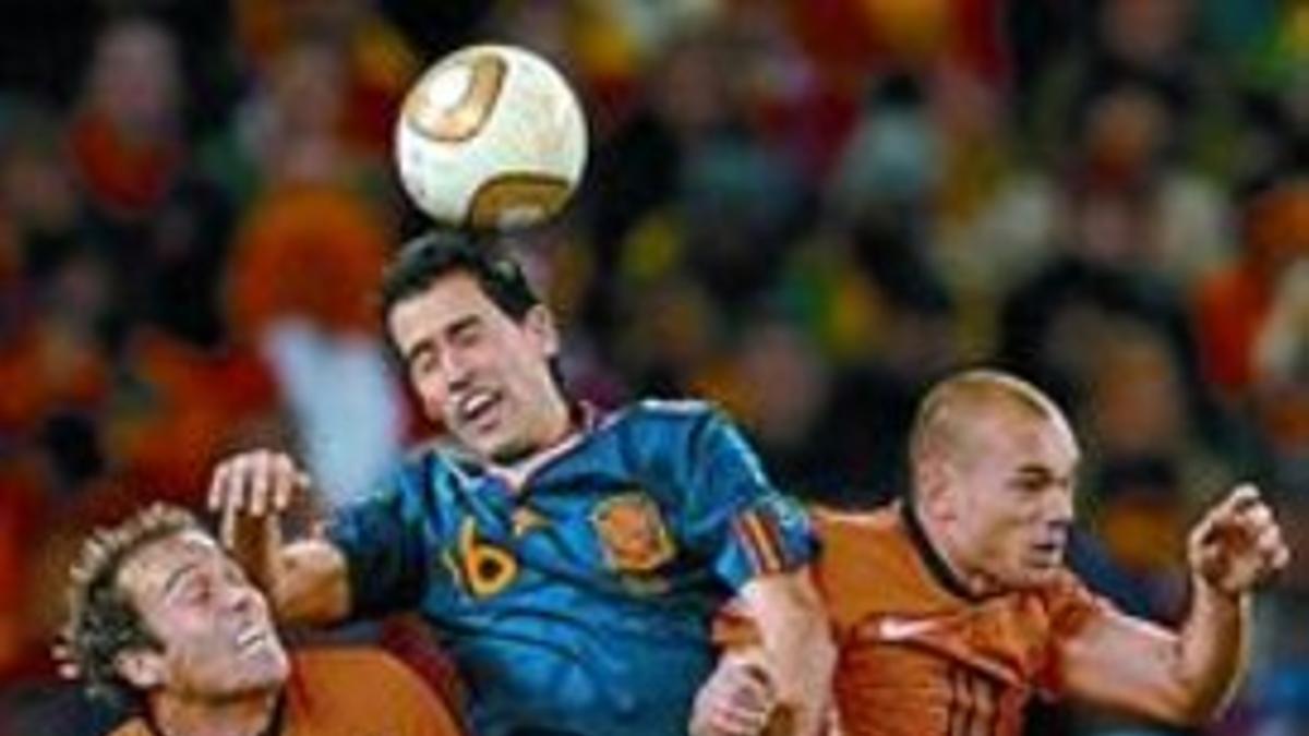 Orgullo 8 Busquets despeja un balón entre Mathijsen y Sneijder.