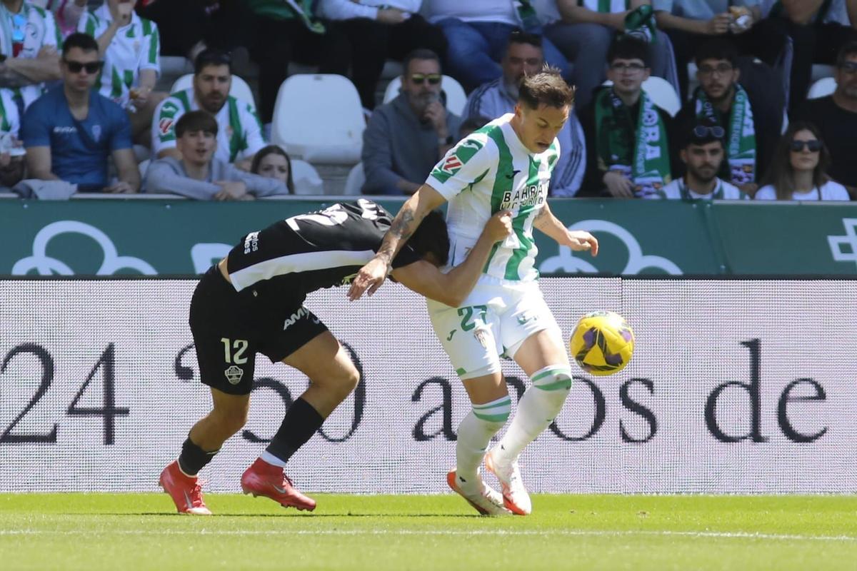 Christian Carracedo defiende el esférico durante un lance del Córdoba CF-Elche.