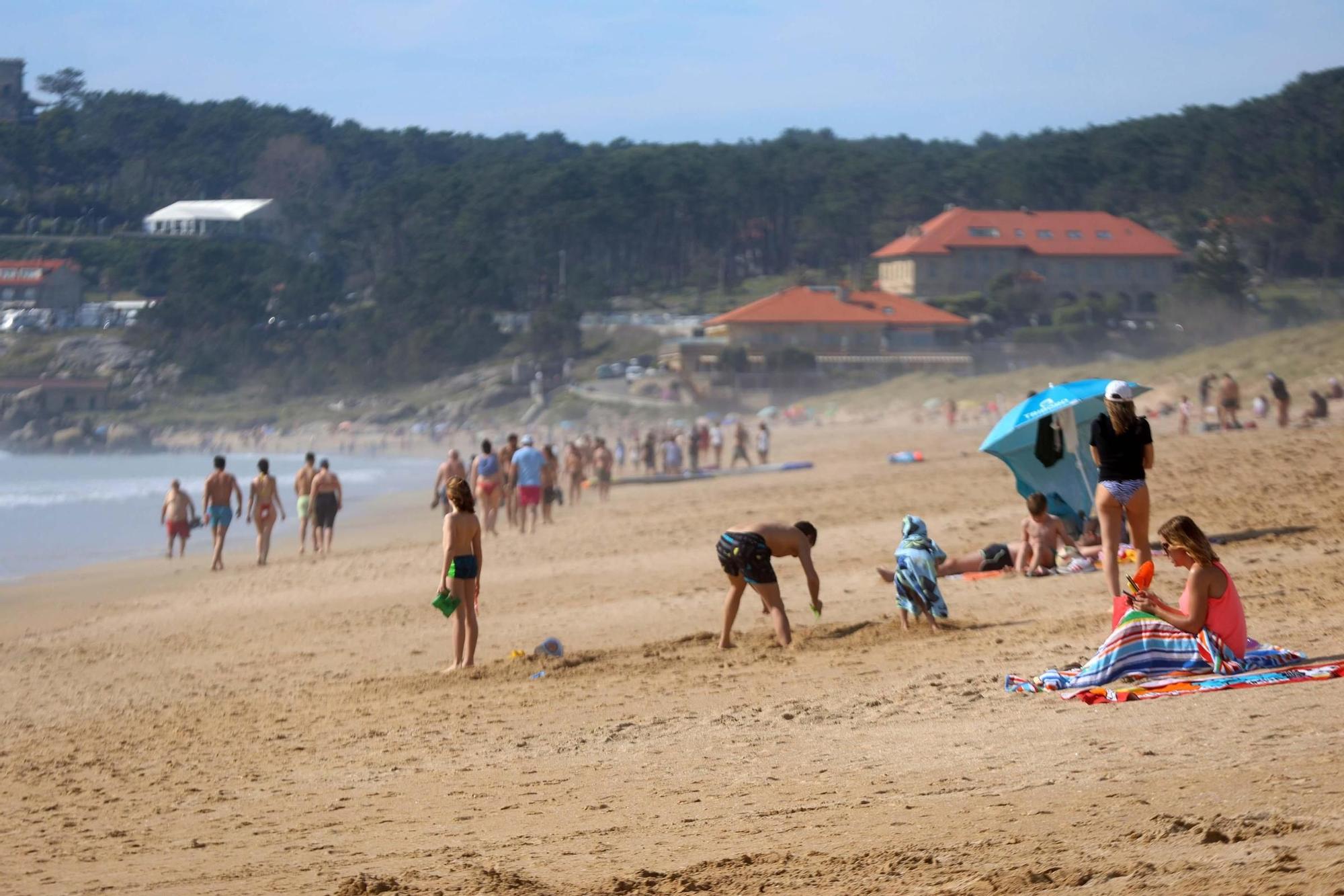 Arousanos y turistas disfrutan en las playas de un anticipio del verano.