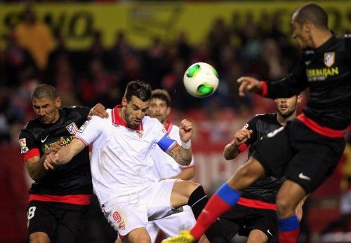Sevilla's Negredo and Atletico Madrid's Diaz fight for the ball during their Spanish King's Cup semi-final second leg soccer match in Seville