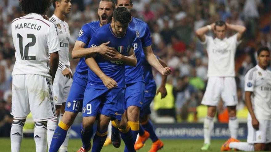 Bonucci y Chiellini (tapado) felicitan a Morata por su gol al Madrid en el Santiago Bernabéu.