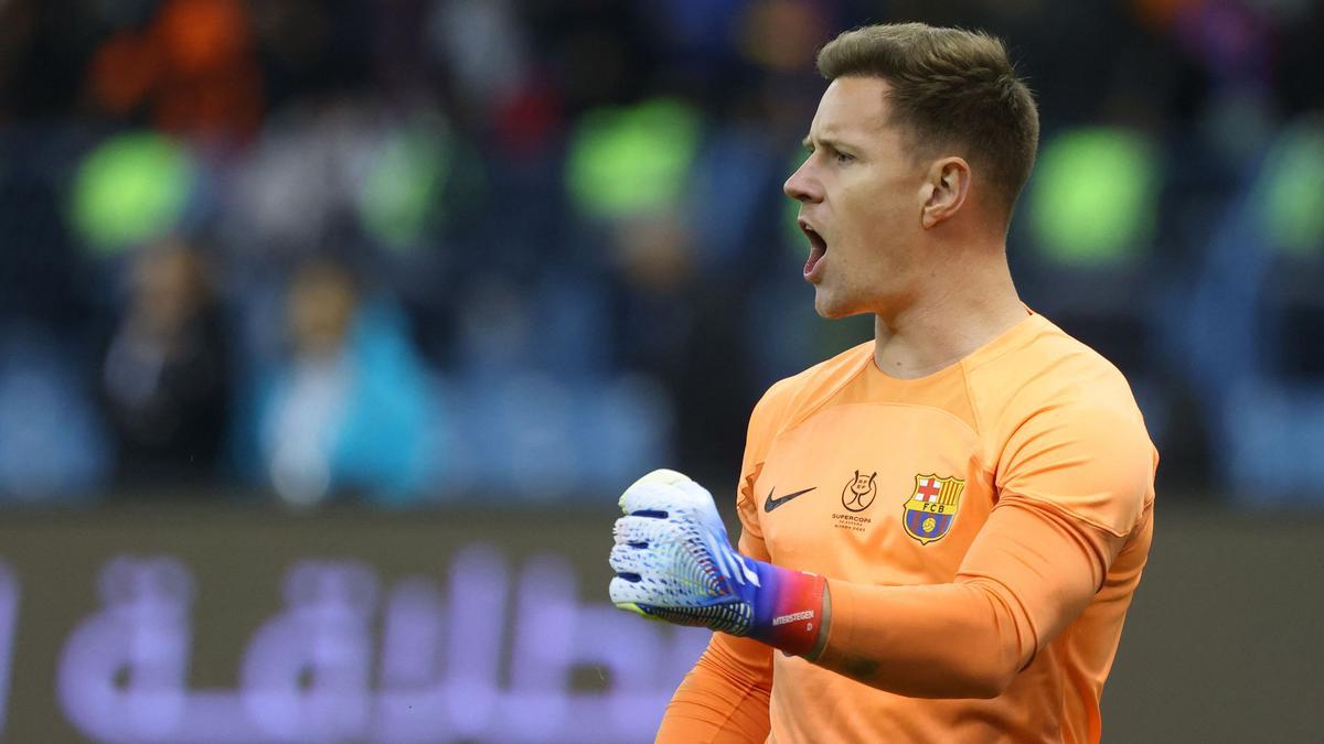 Barcelona's German goalkeeper Marc-Andre ter Stegen celebrates saving a shot during the penalties shootout during the Spanish Super Cup semi-final football match between Real Betis and FC Barcelona at the King Fahd International Stadium in Riyadh, Saudi Arabia, on January 12, 2023. (Photo by Fayez NURELDINE / AFP)